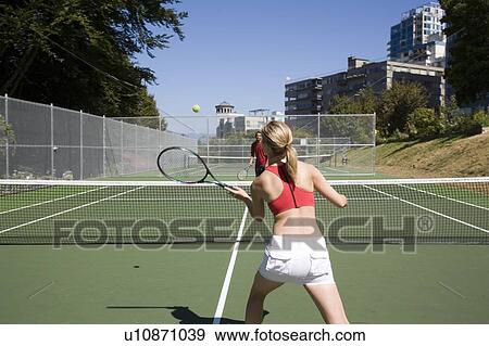 Stock Photo - Couple playing tennis; Canada, British Columbia, Vancouver. Fotosearch