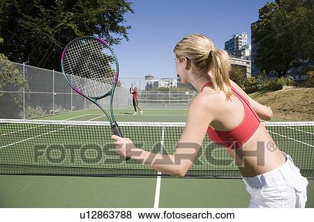 Couple playing tennis; Canada, British Columbia, Vancouver View Large Photo Image Stock Photo - Couple playing tennis; Canada, British Columbia, Vancouver. Fotosearch