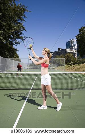 Couple playing tennis; Canada, British Columbia, Vancouver View Large Photo Image Stock Photography - Couple playing tennis; Canada, British Columbia, Vancouver. Fotosearch