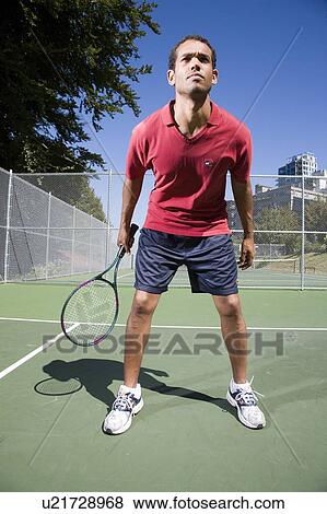 Stock Photo - Man on tennis court; Canada, British Columbia, Vancouver. Fotosearch