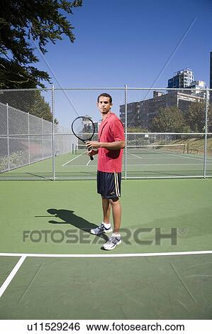 Stock Photograph - Man on tennis court; Canada, British Columbia, Vancouver. Fotosearch