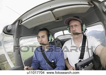 Picture - Pilots in a Cessna 172 In Flight, Vancouver, B. C.. Fotosearch