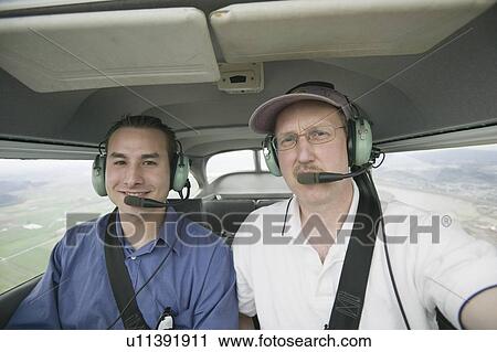 Stock Image - Pilots in a Cessna 172 In Flight, Vancouver, B. C.. Fotosearch