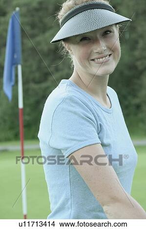 Picture - Woman on organic golf course, Clear Lake Golf Course, Riding Mountain National Park, Manitoba, Canada. Fotosearch