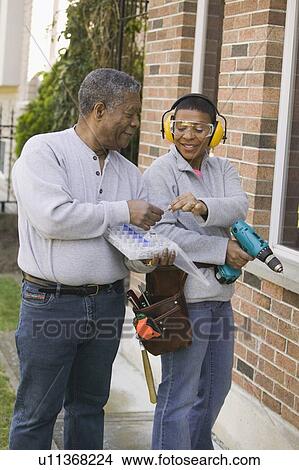 Picture - African American couple doing home improvement, Vancouver, BC. Fotosearch