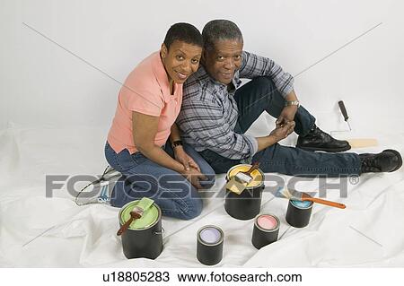 Stock Image - African American Couple Doing Home Improvement Painting, Canada, British Columbia. Fotosearch
