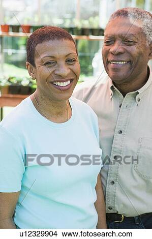 Senior African America Couple in Their Greenhouse, Vancouver, BC View Large Photo Image Picture - Senior African America Couple in Their Greenhouse, Vancouver, BC. Fotosearch