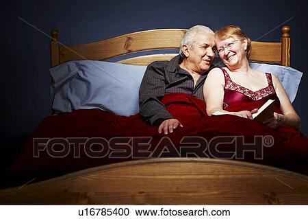 Senior Couple cuddling in bed View Large Photo Image Stock Image - Senior Couple cuddling in bed. Fotosearch