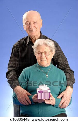 Stock Photo - Senior Couple hugging; Canada, Saskatchewan, Regina. Fotosearch