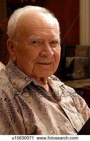 Stock Image - Senior male sitting; Canada, Saskatchewan, Regina. Fotosearch
