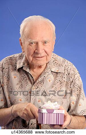 Senior male sitting; Canada, Saskatchewan, Regina View Large Photo Image Stock Photo - Senior male sitting; Canada, Saskatchewan, Regina. Fotosearch