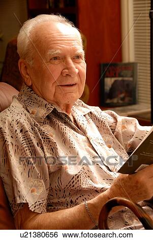 Stock Photograph - Senior male sitting; Canada, Saskatchewan, Regina. Fotosearch