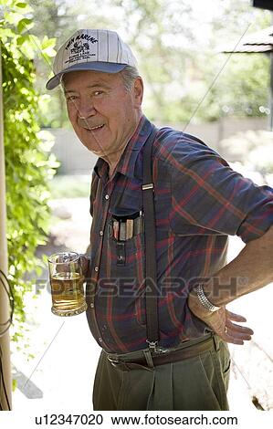Stock Image - Senior man enjoying a refreshment, Saskatchewan, Canada. Fotosearch