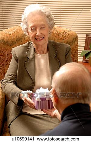 Stock Image - Senior Woman in Armchair; Canada, Saskatchewan, Regina. Fotosearch