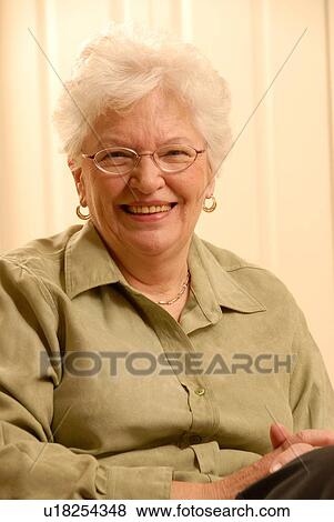 Stock Photo - Senior Woman in chair; Canada, Saskatchewan, Regina. Fotosearch