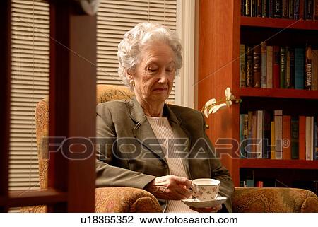 Stock Image - Senior Woman in Library; Canada, Saskatchewan, Regina. Fotosearch