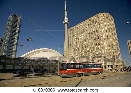 Stock Photograph - Streetcar in Toronto in front of CN Tower and Rogers Centre, formerly the Skydome. Fotosearch