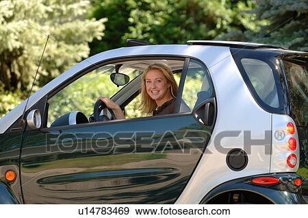 Young woman sitting in smart car, Regina, Saskatchewan View Large Photo Image Stock Photo - Young woman sitting in smart car, Regina, Saskatchewan. Fotosearch