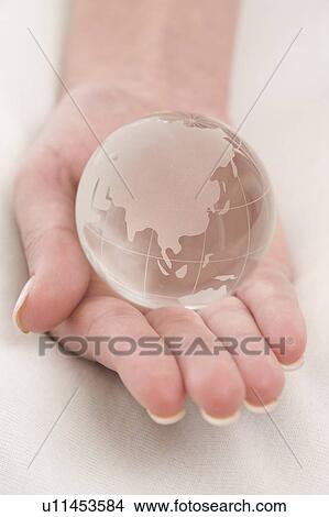 Picture - a hand with a globe. Fotosearch