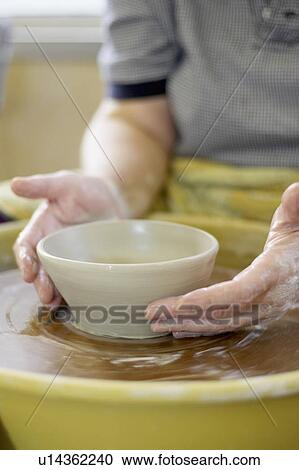 Hands molding a piece of pottery on a wheel-head, Burlington, Ontario View Large Photo Image Stock Image - Hands molding a piece of pottery on a wheel-head, Burlington, Ontario. Fotosearch