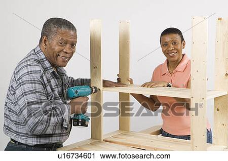 African American Couple Doing Home Improvement, Assembling a Shelving Unit, Canada, British Columbia View Large Photo Image Stock Image - African American Couple Doing Home Improvement, Assembling a Shelving Unit, Canada, British Columbia. Fotosearch