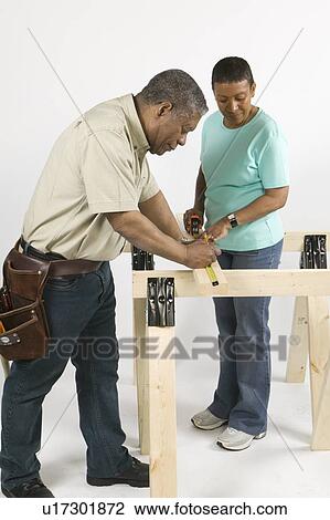 Stock Image - African American Couple Doing Home Improvement, Canada, British Columbia. Fotosearch