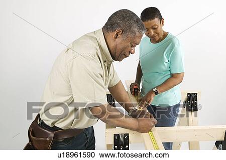 Stock Image - African American Couple Doing Home Improvement, Canada, British Columbia. Fotosearch