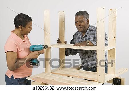 African American Couple Doing Home Improvement, Assembling a Shelving Unit, Canada, British Columbia View Large Photo Image Stock Image - African American Couple Doing Home Improvement, Assembling a Shelving Unit, Canada, British Columbia. Fotosearch