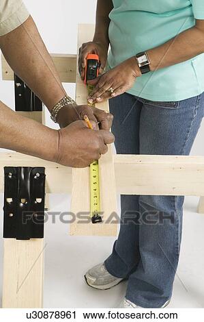 Stock Image - African American Couple Doing Home Improvement, B. C.. Fotosearch