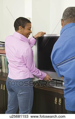 African American couple installing a flat screen TV, Vancouver, BC View Large Photo Image Stock Image - African American couple installing a flat screen TV, Vancouver, BC. Fotosearch