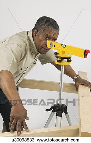 African American Man Doing Home Improvement, Using Laser Level, Vancouver, BC View Large Photo Image Stock Image - African American Man Doing Home Improvement, Using Laser Level, Vancouver, BC. Fotosearch