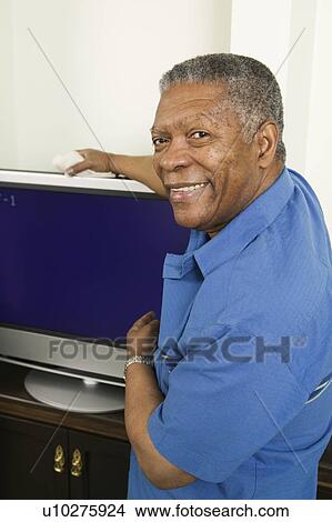 African American man with his new flat screen TV, Vancouver, BC View Large Photo Image Picture - African American man with his new flat screen TV, Vancouver, BC. Fotosearch