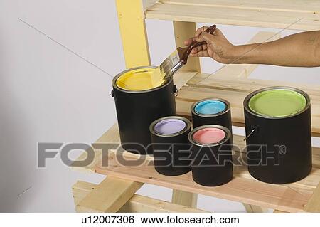 Stock Photograph - African American Woman Doing Home Improvement Painting, Canada, British Columbia. Fotosearch