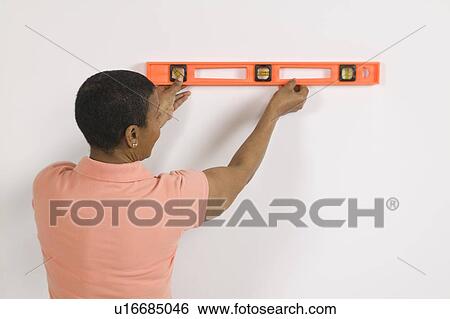 African American Woman Doing Home Improvement, Using a Spirit Level, Canada, British Columbia View Large Photo Image Stock Photograph - African American Woman Doing Home Improvement, Using a Spirit Level, Canada, British Columbia. Fotosearch