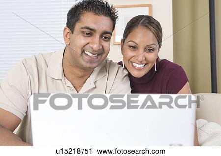 Stock Image - Man and woman with the laptop, Winnipeg, Canada. Fotosearch