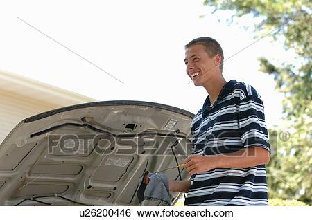 Teenage boy checking oil, Regina, Saskatchewan View Large Photo Image Stock Photograph - Teenage boy checking oil, Regina, Saskatchewan. Fotosearch