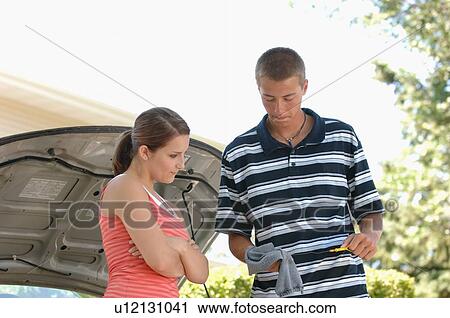 Teenage boy showing teenage girl how to check oil, Regina, Saskatchewan View Large Photo Image Stock Image - Teenage boy showing teenage girl how to check oil, Regina, Saskatchewan. Fotosearch