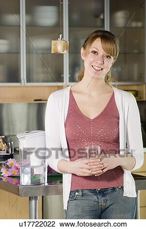 Woman with glass of water from filtred jug View Large Photo Image Stock Image - Woman with glass of water from filtred jug. Fotosearch