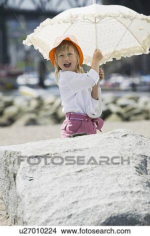 Picture - 4 year old with White Parasol, Sunset Beach, Vancouver, B. C.. Fotosearch