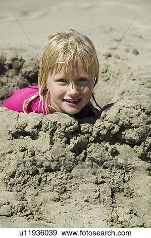 Stock Photo - 7 year old girl playing at a beach, San Diego California. Fotosearch