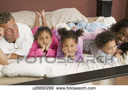 AA mom, Caucasian dad, Mulatto Children, Boy 1. 5 years, girl 3 years, girl 6 years. In bed. View Large Photo Image Stock Photo - AA mom, Caucasian dad, Mulatto Children, Boy 1. 5 years, girl 3 years, girl 6 years. In bed.. Fotosearch