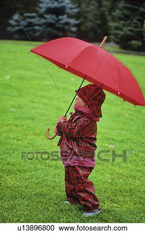 Boy, 2, in red tartan rainsuit, holds red umbrella, Whistler, BC View Large Photo Image Stock Image - Boy, 2, in red tartan rainsuit, holds red umbrella, Whistler, BC. Fotosearch