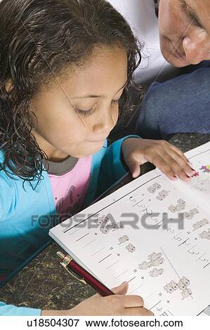 Caucasian dad helping 6 year old Mulatto girl with her arithmetic. View Large Photo Image Stock Photo - Caucasian dad helping 6 year old Mulatto girl with her arithmetic.. Fotosearch