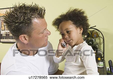 Caucasian father and Mulatto girl 3 years old. Playing with cellphone. View Large Photo Image Stock Photography - Caucasian father and Mulatto girl 3 years old. Playing with cellphone.. Fotosearch