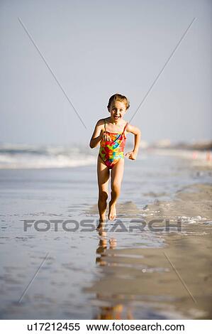 Stock Photography - Girl - (6) running on the beach, Jacksonville, Florida. Fotosearch