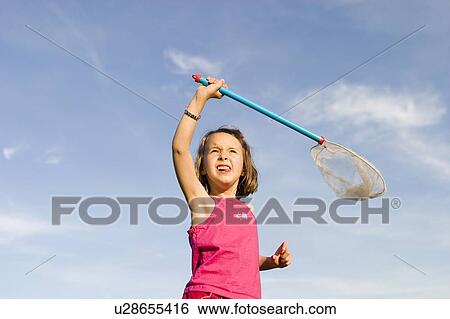 Stock Photograph - Girl - 6 years old with the net in the park, Winnipeg, Canada. Fotosearch