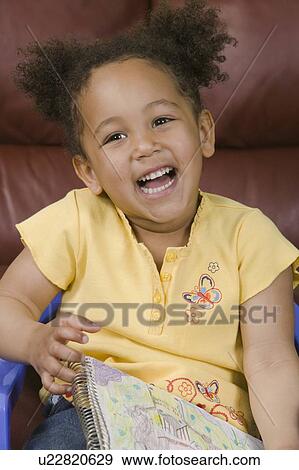 Mulatto girl and her artwork (3 years old). View Large Photo Image Stock Photo - Mulatto girl and her artwork (3 years old).. Fotosearch