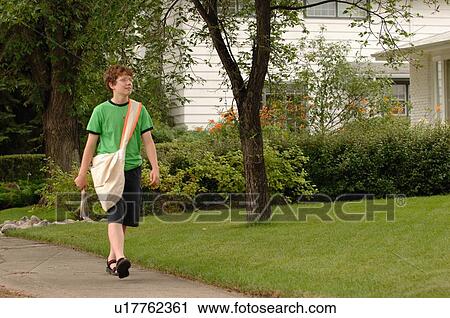 Newspaper boy walking down street, Regina, Saskatchewan View Large Photo Image Stock Image - Newspaper boy walking down street, Regina, Saskatchewan. Fotosearch