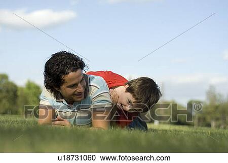 Six year old boy frolics on grass with father, Assiniboine Park, Winnipeg, Canada View Large Photo Image Stock Image - Six year old boy frolics on grass with father, Assiniboine Park, Winnipeg, Canada. Fotosearch