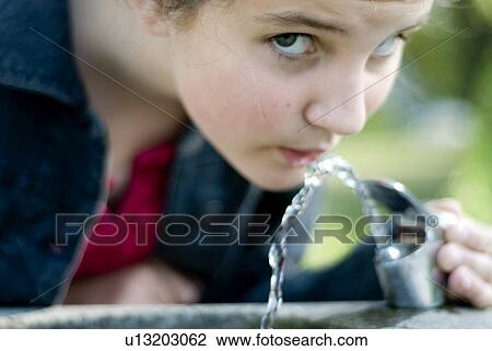 Twelve year old girl drinks from water fountain in park, Winnipeg, Canada View Large Photo Image Stock Image - Twelve year old girl drinks from water fountain in park, Winnipeg, Canada. Fotosearch